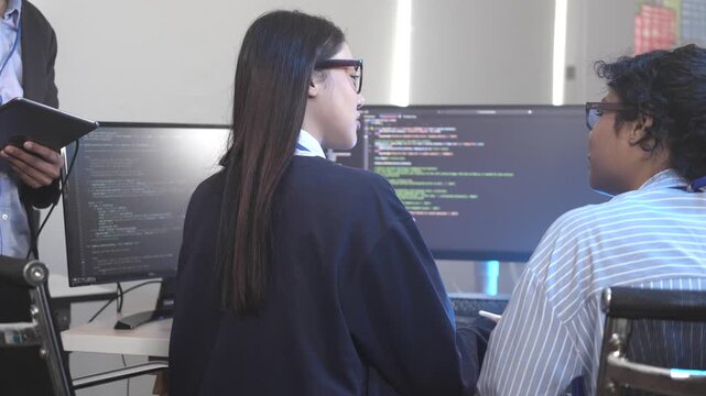 Two female software developers in a pair programming session, debugging complex code on a screen. Concept for agile development, code review, and problem-solving in tech.