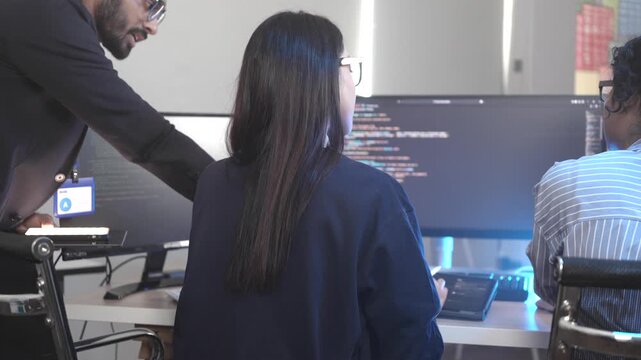 A dedicated IT team collaborates in a command center, working on a critical software deployment or incident response. Concept for system implementation, teamwork, and operations.