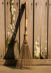 old broom on a wooden background
