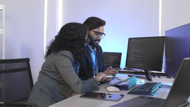 A dedicated IT team collaborates in a command center, working on a critical software deployment or incident response. Concept for system implementation, teamwork, and operations.
