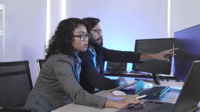 A dedicated IT team collaborates in a command center, working on a critical software deployment or incident response. Concept for system implementation, teamwork, and operations.