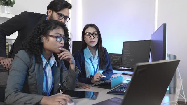 A senior developer mentoring a colleague, pointing at code during a pair programming and debugging session. Concept for teamwork, mentorship, and agile software developm