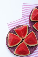 Sliced watermelon in a basket on a table background, summer