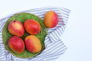 mango in a basket on a table background, summer