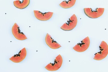 Papaya pieces on white background,  top view