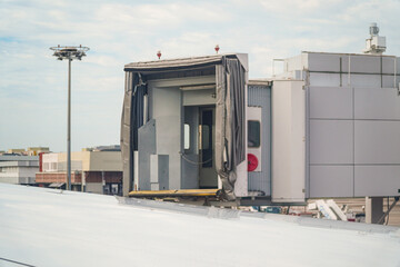 Jet bridge perspective showcasing airplane access, hinting travel possibilities. The ramp offers safe passage, connecting passengers with their flight, promising global explorations and adventure.