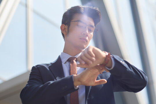 Young businessman checking the time