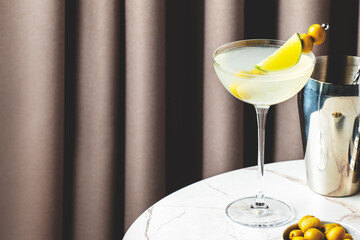 refreshing Mexican Martini with olives and lime in a cozy cocktail lounge setting