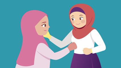Fototapeta premium One sister fixing the other s dress hijab hair