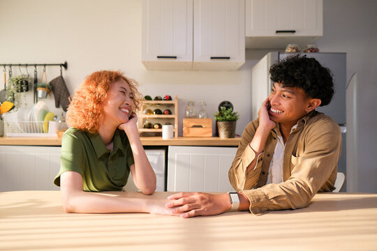 Diverse young adult couple spending quality time together in house.