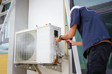Man uninstall an old air conditioner, Repairman fix air conditioning systems, Male technician...