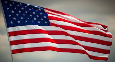 Waving Patriotic Flag with Red White and Blue Stripes Against Cloudy Sky