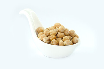 Chickpeas in a bowl on a white background. Scientific name: Cicer arietinum) is a plant in the legume family. The seeds are high in protein.