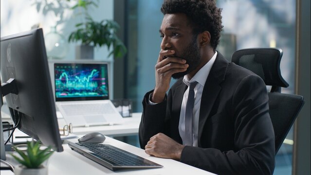 Scared shocked African American man businessman sad failure male frustrated upset guy business manager employee working with computer bad news lose problem online shock stress pc trouble office worker