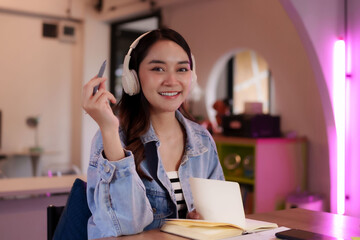 Asian adult freelancer digital nomad working coworking space productive focused creative environment