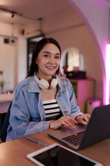 Young asian freelancer student using laptop for remote work successful with online business career...
