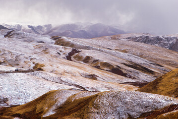 Snow-covered Tibetan highlands reveal a wintery landscape of mountains and roads