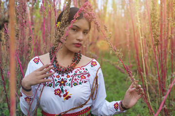 Indigenous farmer woman posing in quinoa field at sunset