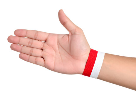 Hand wearing red and white Indonesian flag ribbon on wrist with handshake pose isolated on transparent png