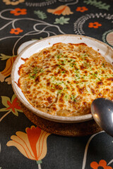 Delicious Cheesy Baked Rice with Golden Crust and Fresh Herbs