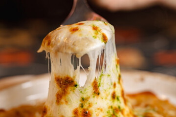 Delicious Cheese Pull: A Close-Up View of Melted, Stringy Perfection