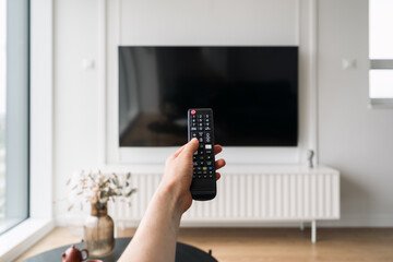 Modern living room with smart TV and remote control for entertainment