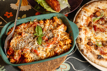 Delicious Italian Pasta and Pizza Served on a Cozy Table