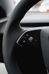 A Close-Up View of a Car's Steering Wheel with Control Buttons