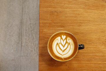  a cup of latte art coffee on wooden background                                                                                                                                                         