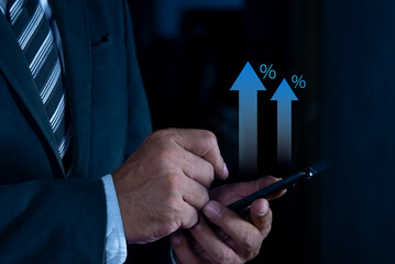 Businessman hand using smartphone with growth up arrow, saving money wealth and financial concept, Business, finance, investment, Financial planning. Interest rate financial. Investment returns.