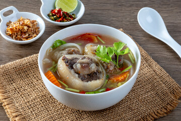 Delicious oxtail soup or buntut soup in a white bowl on the table.