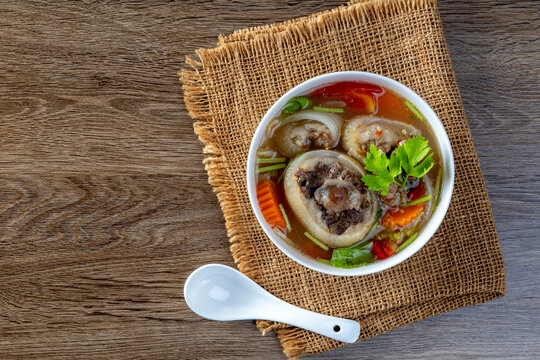 Delicious oxtail soup or buntut soup in a white bowl on the table.