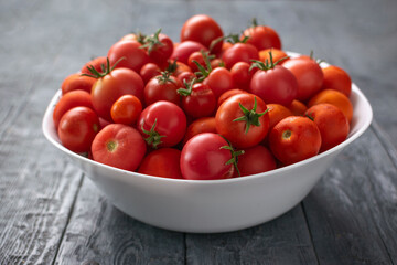 Fresh Red Tomatoes in White Bowl on Rustic Wooden Table - Vibrant and Organic