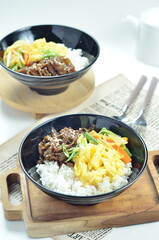 Yakiniku, grilled beef meats topped on a bowl of rice with vegetables, in the local restaurant Jakarta