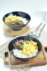 Yakiniku, grilled beef meats topped on a bowl of rice with vegetables, in the local restaurant...