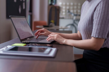 Adult Asian woman professional freelancer working laptop coworking space digital remote work...