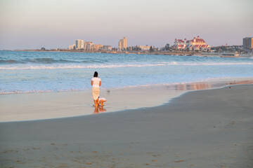 Mum and child seen standing along coastline