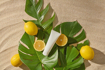 Minimal summer flatlay with sunscreen tube, lemons, and tropical leaves on sand, ideal for beach...