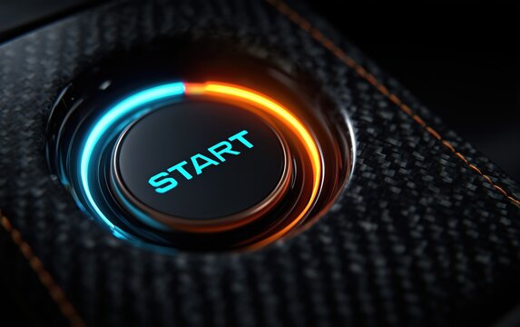 Close-up of illuminated car start engine button in dark interior