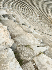 Ancient stone seating in an archaeological site showing remnants of historical theater design