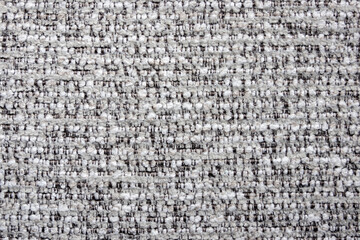 close-up shot of a tightly woven fabric with a mix of light gray and darker threads