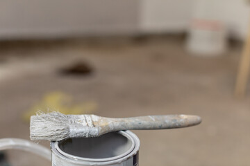 A Paint Brush is Resting Carefully on a Can Inside a Renovation Setting and Environment