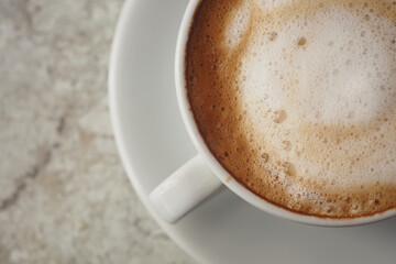 Smooth cappuccino served in a white cup on a saucer