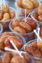 Sweet treats displayed in small containers at a market