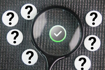 Magnifying glass with right or true and question mark symbol. symbolizing investigation,...