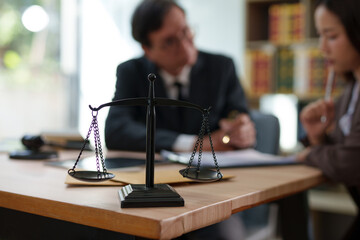 Lawyers are sitting in a meeting, searching for legal documents at the office.	
