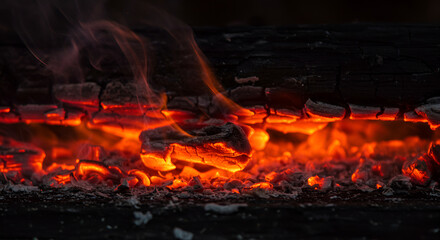 Blazing orange and red flames from a warm wood-burning fireplace at night