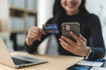 Businesswoman making online payment using credit card and smartphone