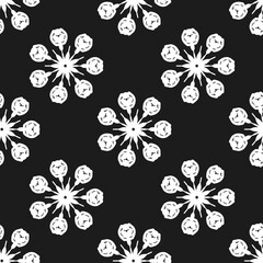 Seamless white floral pattern with hand-drawn flower shapes arranged in radial symmetry on black background. Suitable for fabric, wallpaper, packaging, and monochrome design projects.