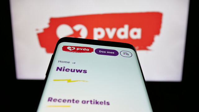 Stuttgart, Germany - 07-10-2025: Mobile phone with website of Partij van de Arbeid van Belgie (PVDA) on screen in front of logo. Focus on top-left of phone display.